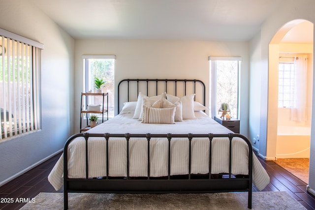 4386 E Mine Shaft Rd, San Tan Valley, AZ 85143 - bedroom with arched walkways, baseboards, and wood finished floors