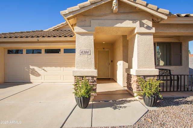 4386 E Mine Shaft Rd, San Tan Valley, AZ 85143 - view of front of home featuring a tile roof, driveway, stucco siding, a garage, and a porch