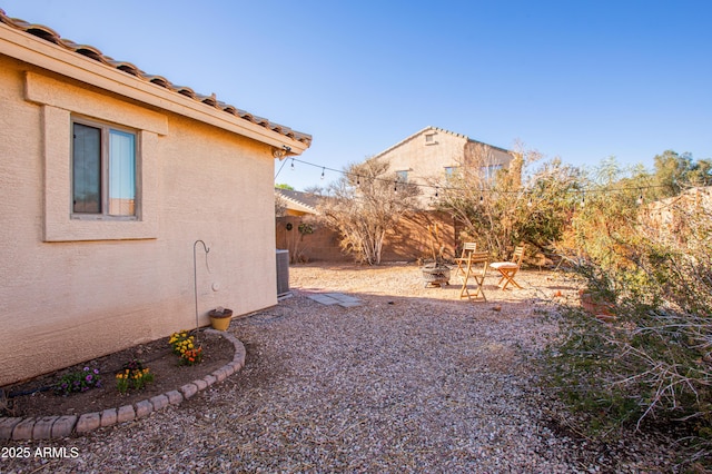 4386 E Mine Shaft Rd, San Tan Valley, AZ 85143 - view of yard with central AC unit, a fire pit, and fence