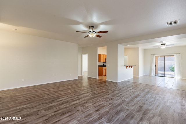 unfurnished room with ceiling fan and hardwood / wood-style floors