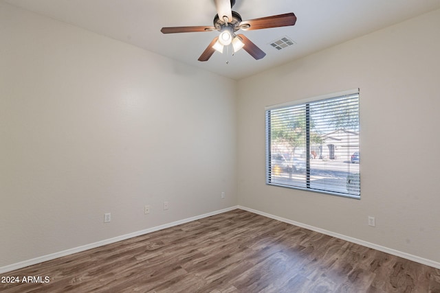 spare room with ceiling fan and hardwood / wood-style flooring