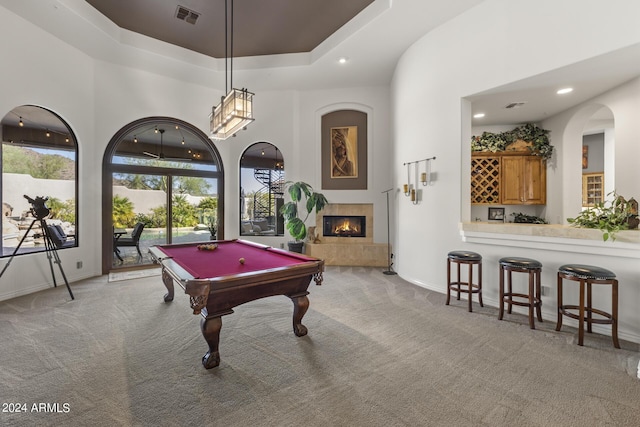 recreation room with light colored carpet, a high ceiling, and billiards