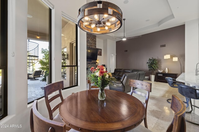 dining area with a tray ceiling and a chandelier