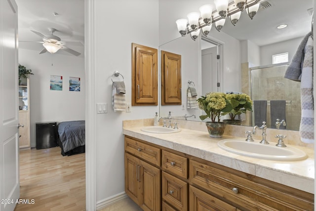 bathroom with vanity, hardwood / wood-style flooring, ceiling fan, and a shower with shower door