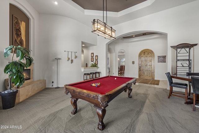 playroom with carpet, a fireplace, pool table, and a high ceiling