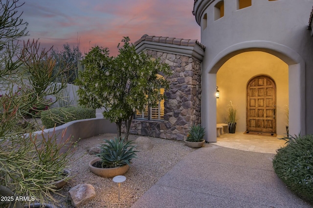 view of exterior entry at dusk