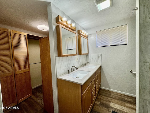 bathroom with vanity, hardwood / wood-style flooring, and a textured ceiling