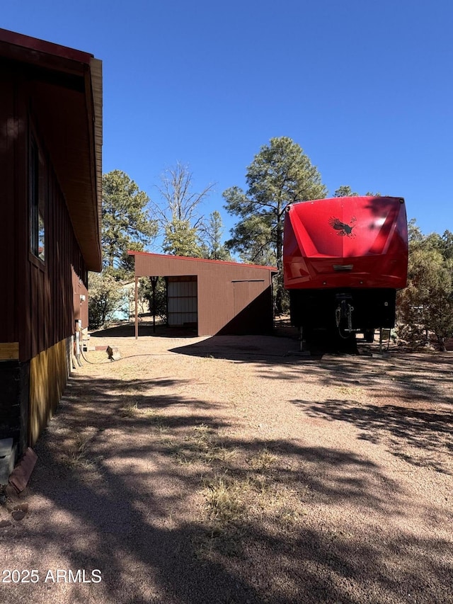 view of side of home featuring an outbuilding