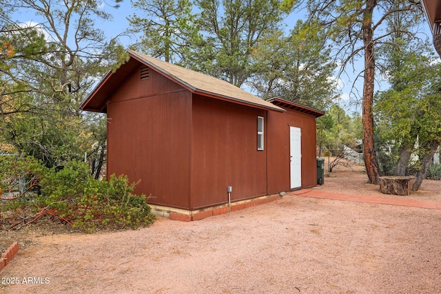 view of property exterior with an outdoor structure