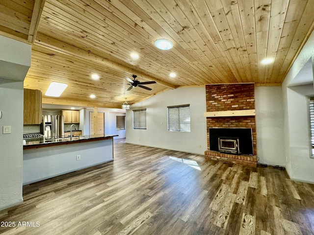 unfurnished living room with hardwood / wood-style floors, vaulted ceiling with beams, and wooden ceiling