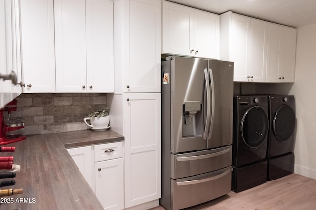 5102 W Whispering Wind Dr, Glendale, AZ 85310 - kitchen with stainless steel refrigerator with ice dispenser, washing machine and clothes dryer, wooden counters, decorative backsplash, and white cabinetry