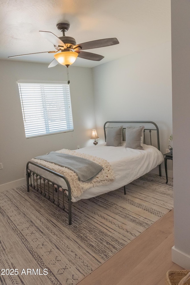 5102 W Whispering Wind Dr, Glendale, AZ 85310 - bedroom with wood finished floors and a ceiling fan