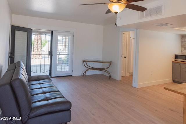 5102 W Whispering Wind Dr, Glendale, AZ 85310 - living area featuring a ceiling fan and light wood-style floors