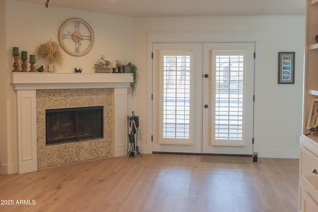 5102 W Whispering Wind Dr, Glendale, AZ 85310 - unfurnished living room with french doors, wood finished floors, and a tiled fireplace