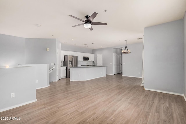 1265 S Aaron Unit 341, Mesa, AZ 85209 - unfurnished living room featuring a ceiling fan, light wood-type flooring, baseboards, a chandelier, and recessed lighting