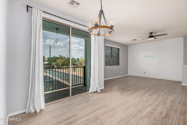 1265 S Aaron Unit 341, Mesa, AZ 85209 - unfurnished room with a chandelier, wood finished floors, and baseboards