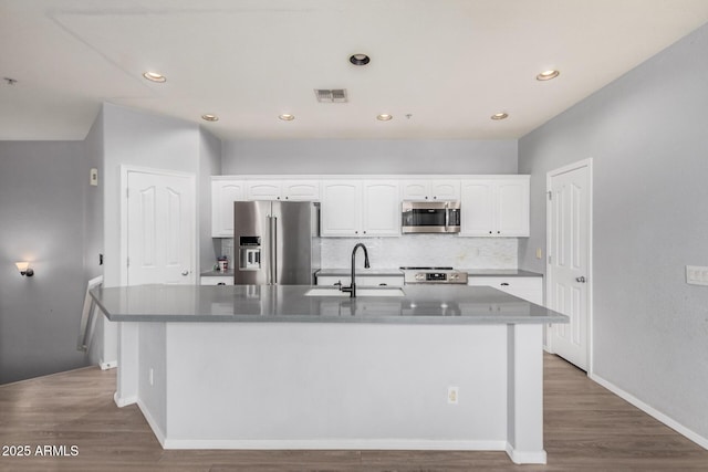 1265 S Aaron Unit 341, Mesa, AZ 85209 - kitchen with stainless steel appliances, a sink, white cabinetry, tasteful backsplash, and recessed lighting