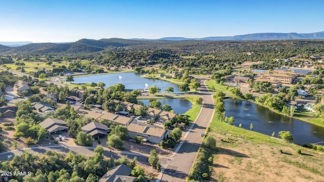 drone / aerial view featuring a residential view and a water and mountain view