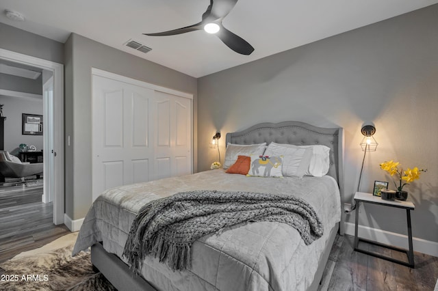 bedroom featuring ceiling fan, dark hardwood / wood-style floors, and a closet