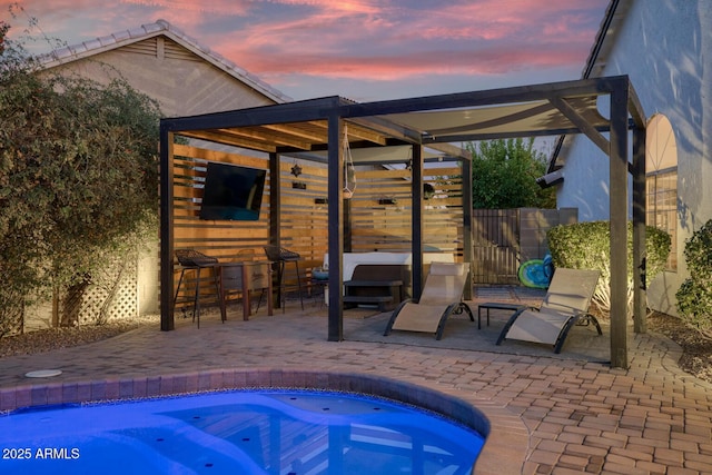 view of pool with a hot tub, a patio, and exterior bar