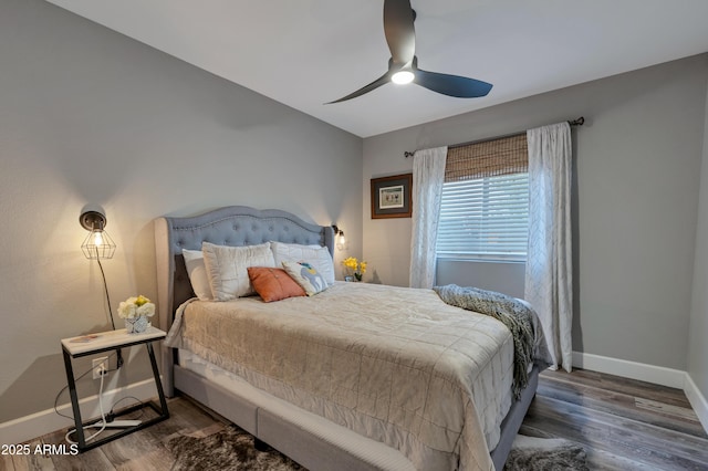 bedroom featuring dark wood-type flooring and ceiling fan