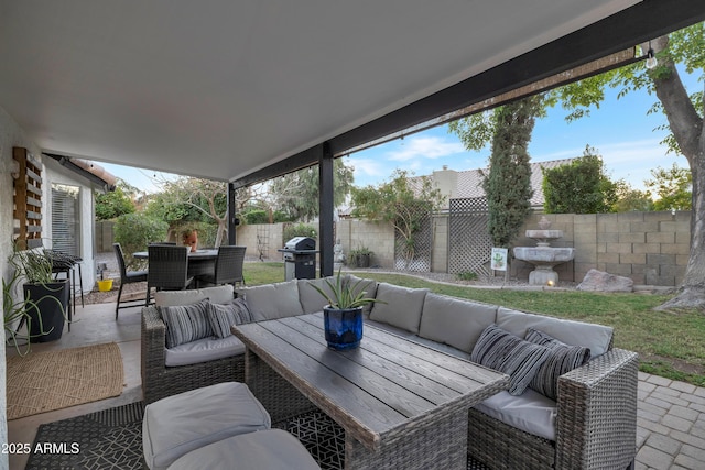 view of patio with an outdoor living space and a grill