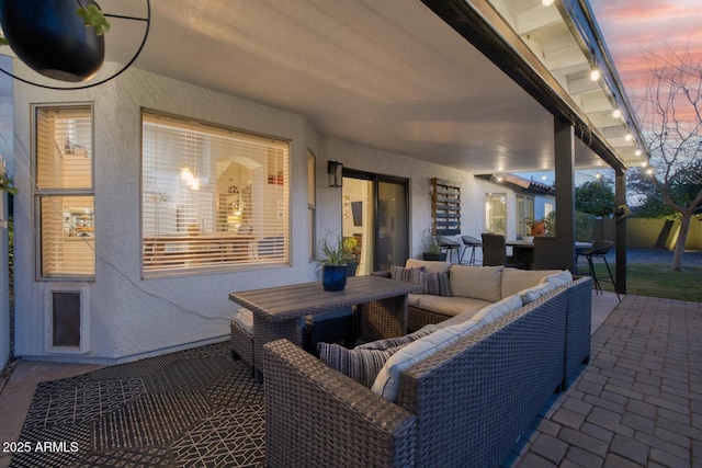 patio terrace at dusk featuring an outdoor living space