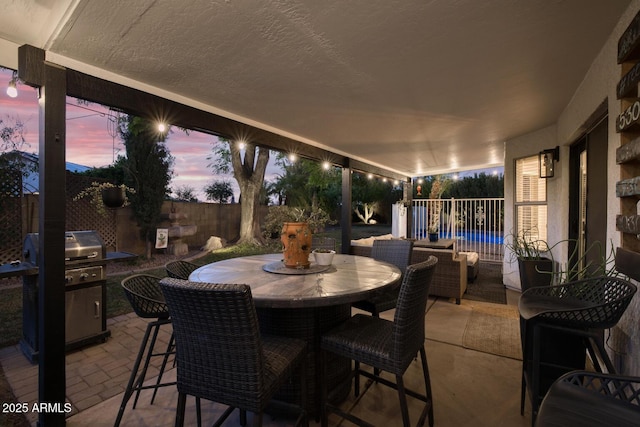 view of patio terrace at dusk