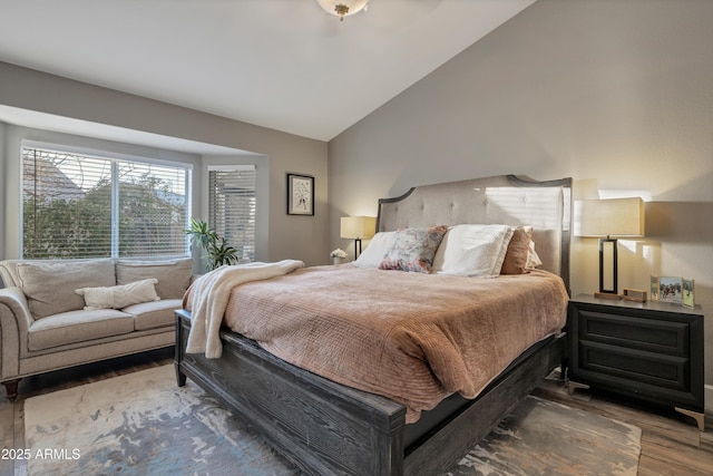 bedroom with lofted ceiling and wood-type flooring