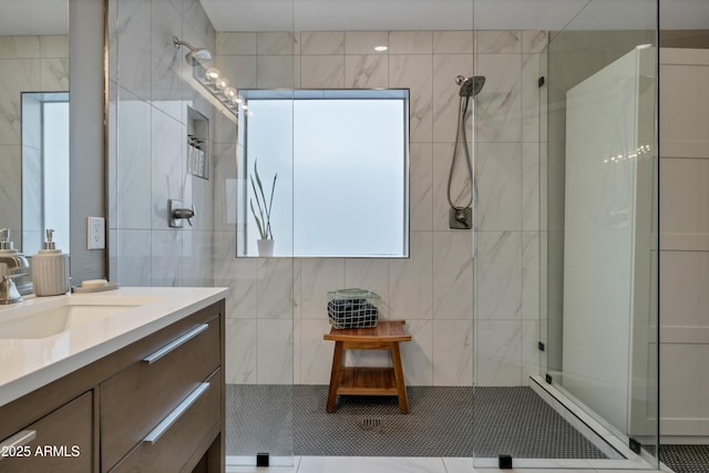 bathroom featuring vanity, tile walls, and walk in shower