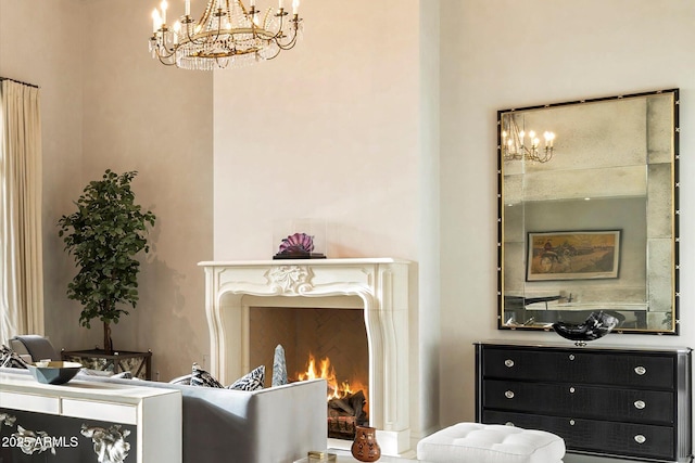 living area with an inviting chandelier and a fireplace