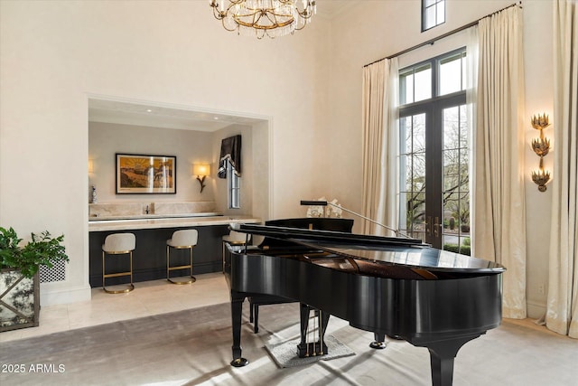 sitting room featuring ornamental molding, french doors, a high ceiling, and tile patterned floors