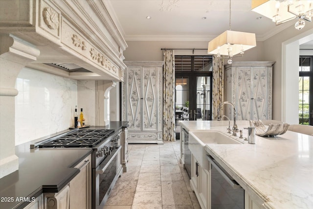 kitchen with stone tile floors, stainless steel appliances, a sink, hanging light fixtures, and crown molding