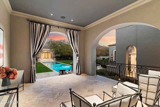 pool at dusk with a patio area and an outdoor pool