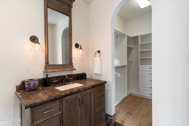 bathroom featuring a closet, vanity, and wood finished floors