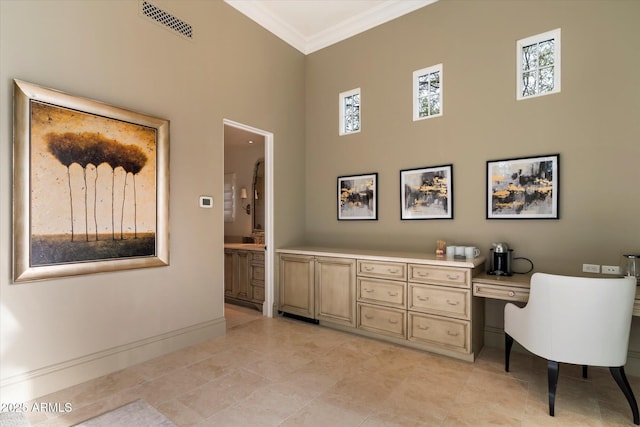 office area featuring a high ceiling, visible vents, crown molding, and baseboards