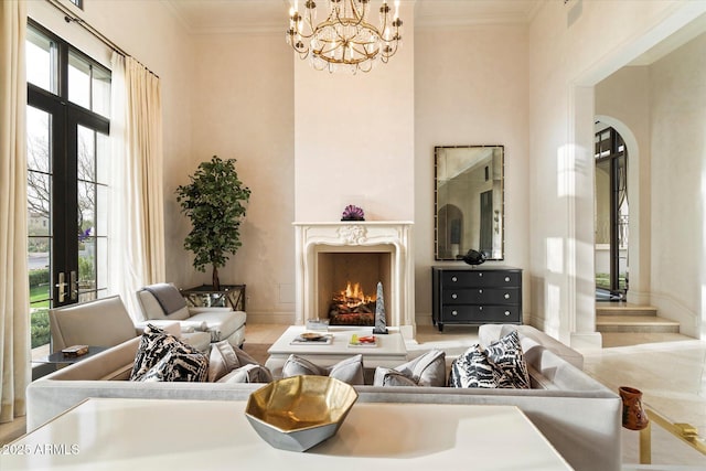 living area with ornamental molding, french doors, and a premium fireplace