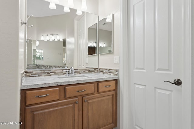 bathroom featuring vanity and decorative backsplash