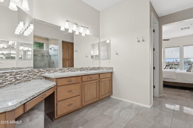 bathroom with walk in shower, tile patterned floors, vanity, and decorative backsplash