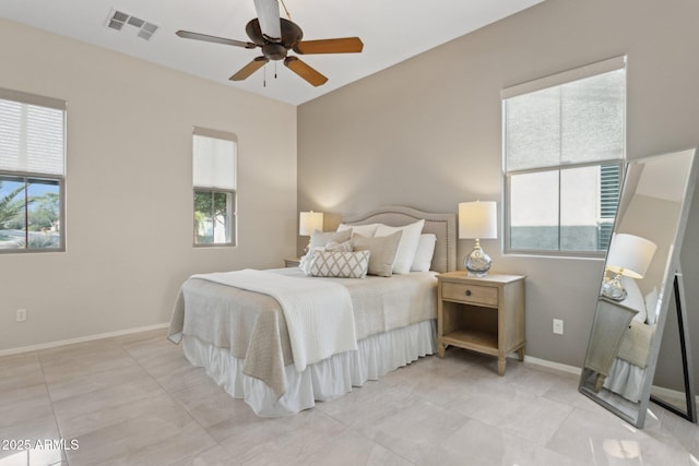 bedroom with multiple windows, light tile patterned flooring, and ceiling fan