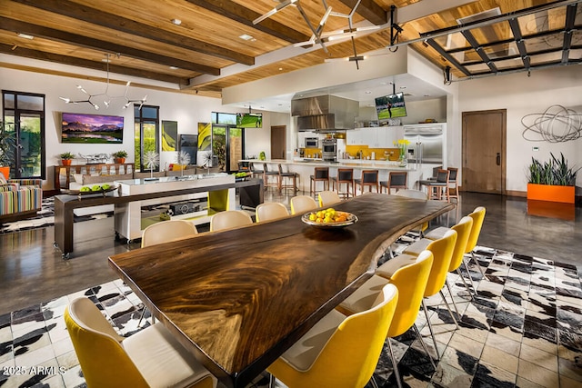 dining area featuring beam ceiling