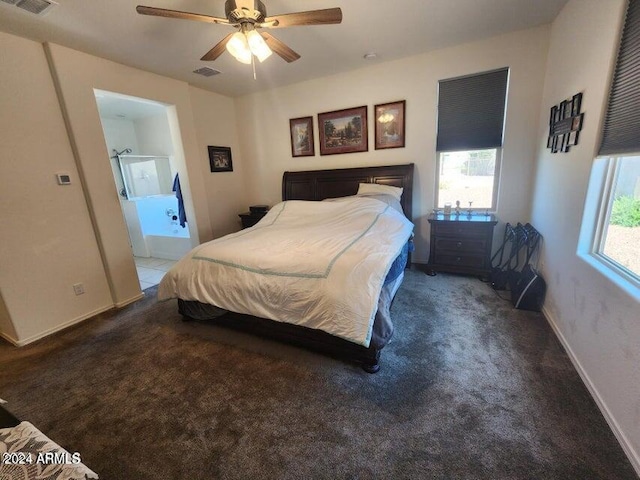 carpeted bedroom with ensuite bath, ceiling fan, and multiple windows