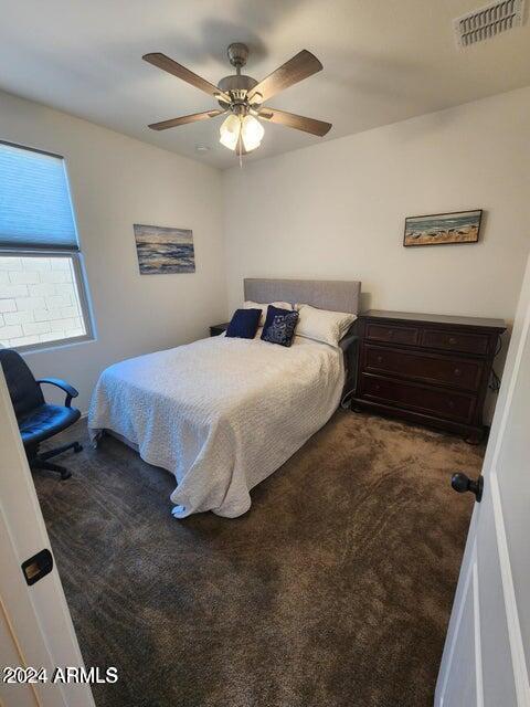 carpeted bedroom featuring ceiling fan