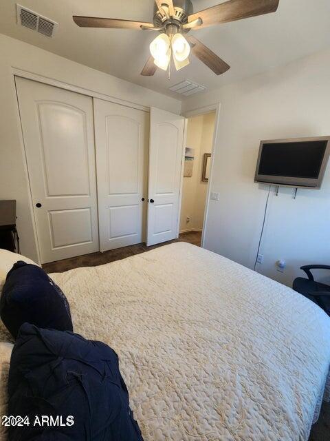 bedroom featuring ceiling fan and a closet