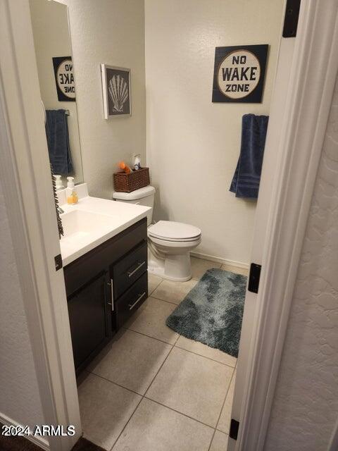 bathroom featuring tile patterned floors, vanity, and toilet