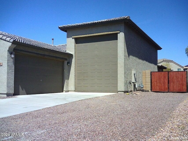 view of side of property with a garage