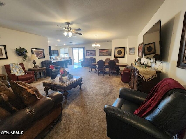 living room with carpet and ceiling fan with notable chandelier