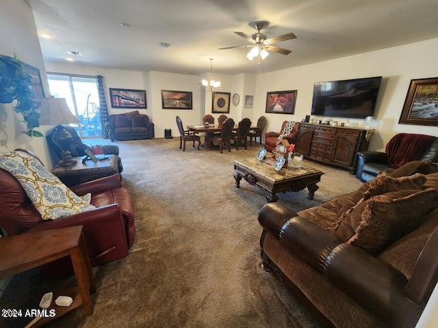 living room with ceiling fan with notable chandelier and light colored carpet