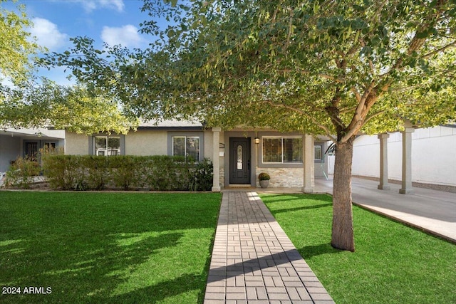 obstructed view of property featuring a front yard