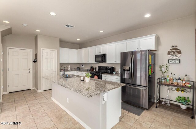 3914 S 58th Ln, Phoenix, AZ 85043 - kitchen featuring black appliances, a sink, white cabinets, light tile patterned floors, and recessed lighting